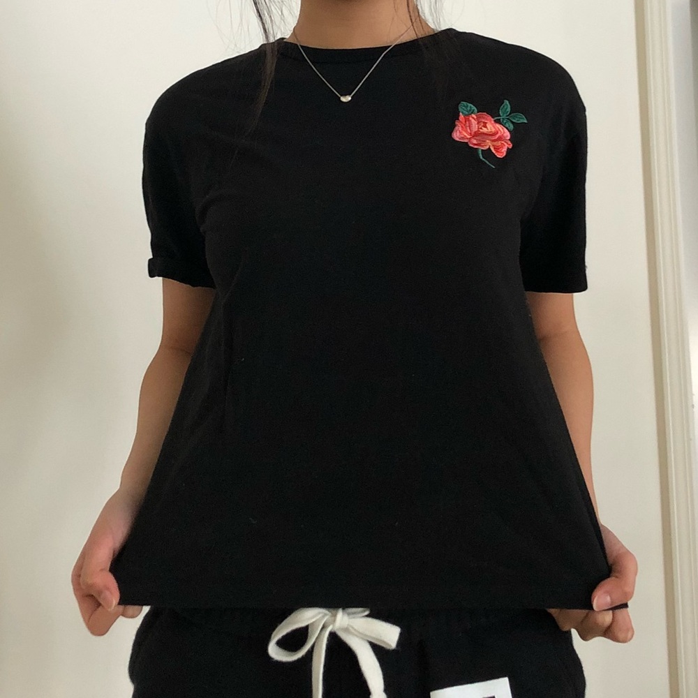 black tee with embroidered rose patch